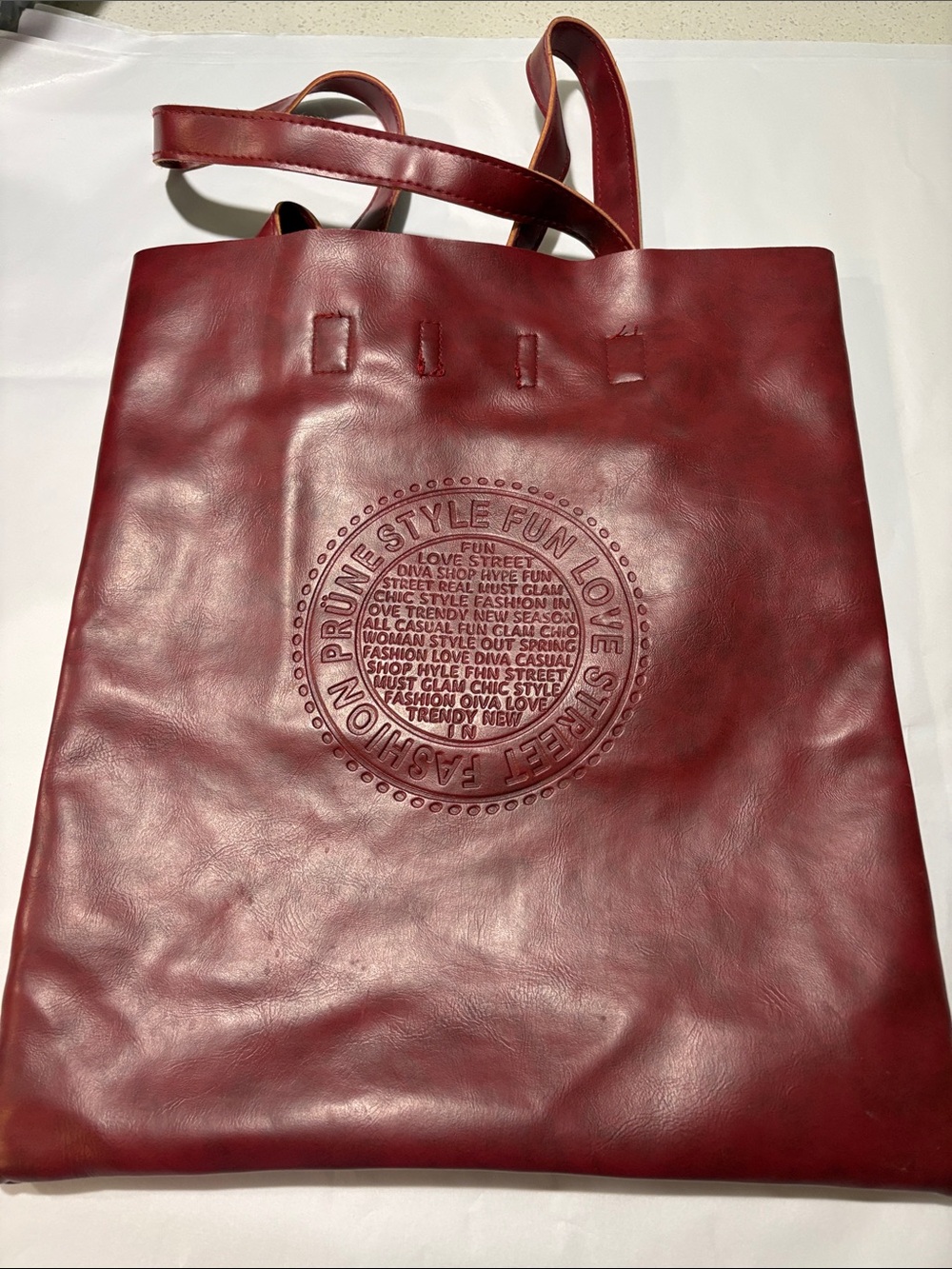 Prune Embossed Round-Logo Vegan Leather Tote in Deep Red
